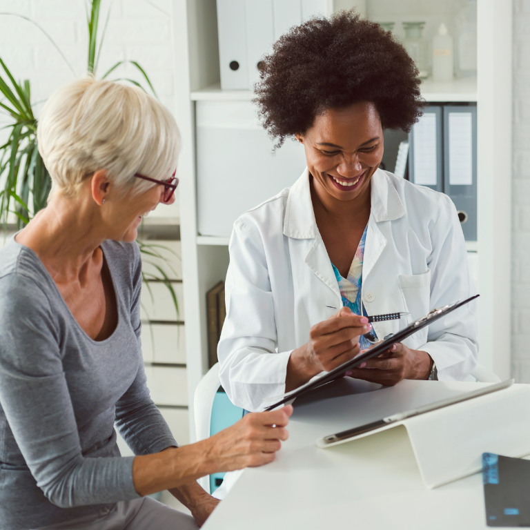 Doctor with a patient talking and looking at a chart